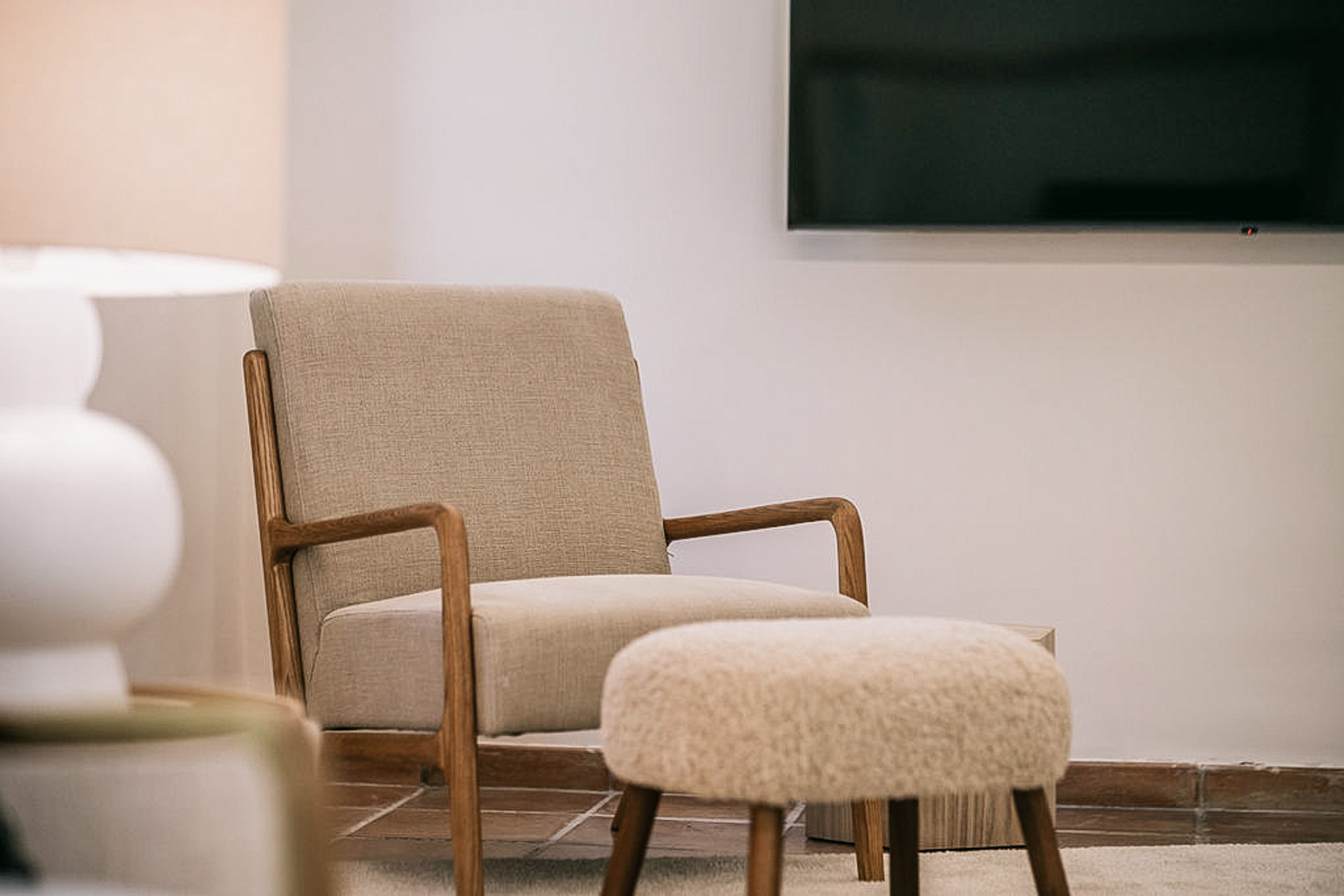 A cozy sitting area within the Junior Suite, featuring comfortable armchairs and a small table.